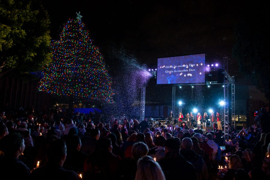 The crowd welcomes the Christmas season with snow, a brightly lit tree and a boisterous, collaborative rendition of O Come All Ye Faithful. | Olivia Blinn/THE CHIMES [file photo]