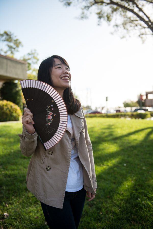 Junior nursing major Soomin Choi holds a traditional Korean fan from her native land. Soomin feels the language barrier causes her to feel shy and often wishes American students would do the hard part for her and approach her first so she could make friends. | Ashleigh Fox/THE CHIMES