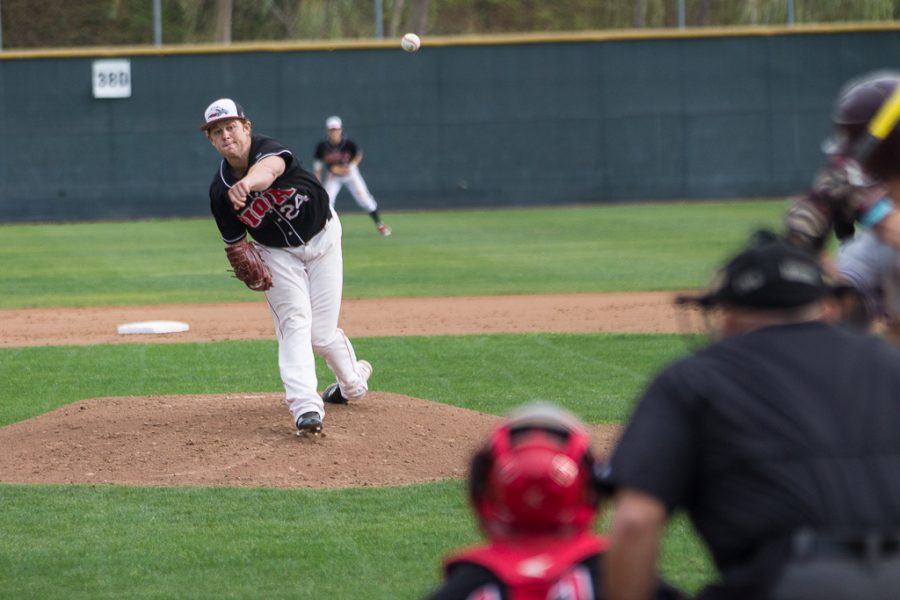Junior Garrett Picha pitches to a player up to bat for Westmont on Jan. 31. The men won two out of the three games played last weekend. | Kalli Thommen/THE CHIMES