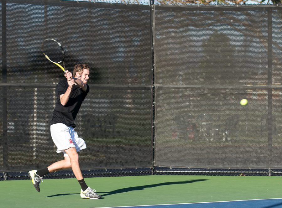 Freshman Luke Mountain powers the ball over the net to his Cal Tech opponent last Saturday. | Ashleigh Fox/THE CHIMES