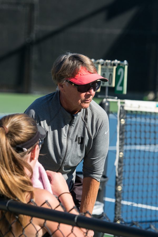 Womens tennis coach Dee Henry talks with doubles team freshman Kelsey Post and Junior Lauren Vogel between sets during Saturdays competition against Cal Tech. | Ashleigh Fox/THE CHIMES