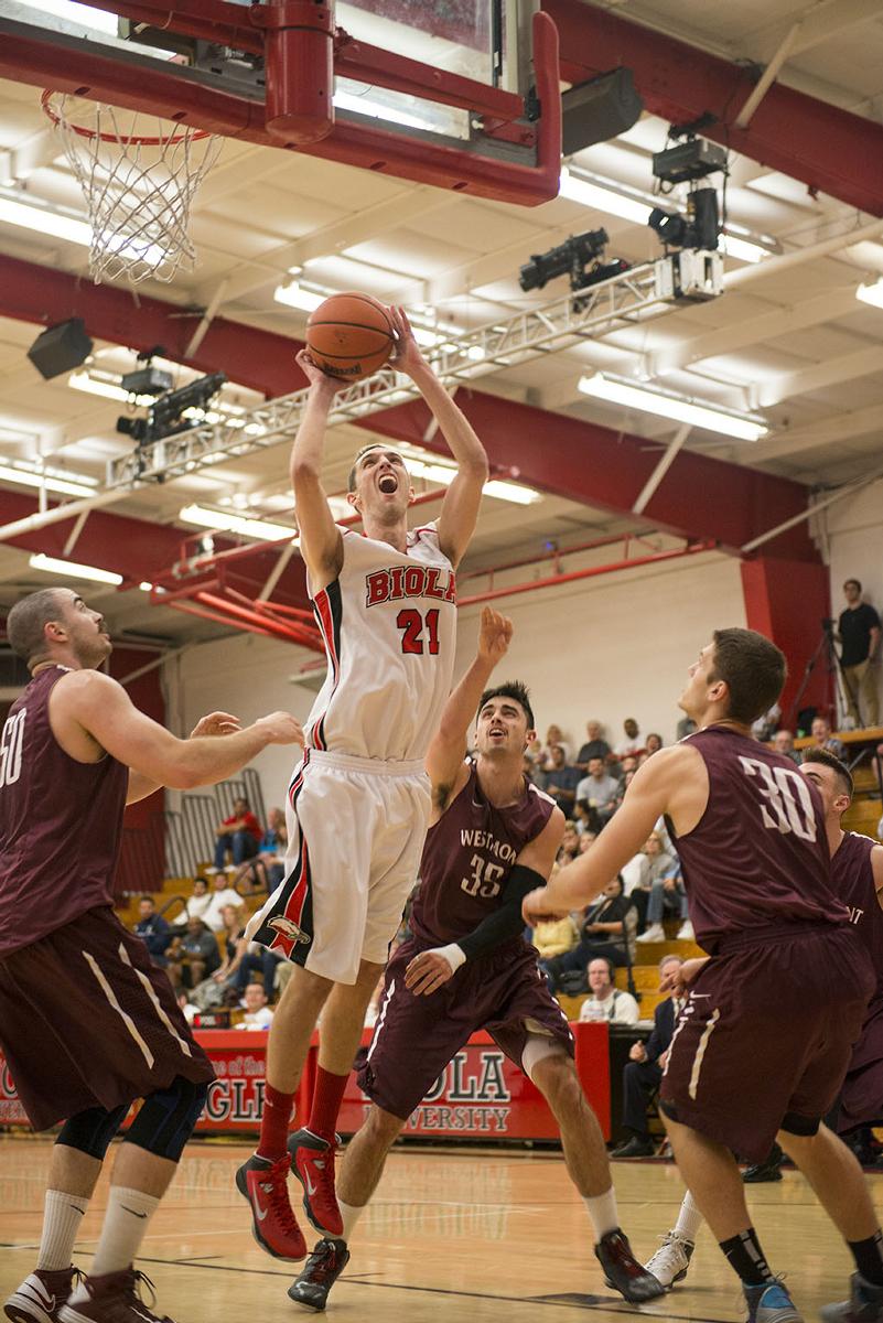 Junior Mike Kurtz goes up for a layup with heavy defense. Kurtz got to shoot one more from the free throw line after getting fouled on the shot. | Ashleigh Fox/THE CHIMES