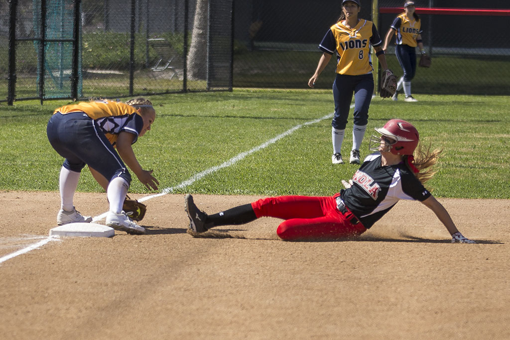 Senior catcher Celina Thornton slides in an effort to get on base to set up a chance to score against the Vanguard Lions on Saturday afternoon. Although the Eagles defeated the Lions in the first game 3-2, they were not able to produce similar results in the second game and fell 2-0. | Aaron Fooks/THE CHIMES