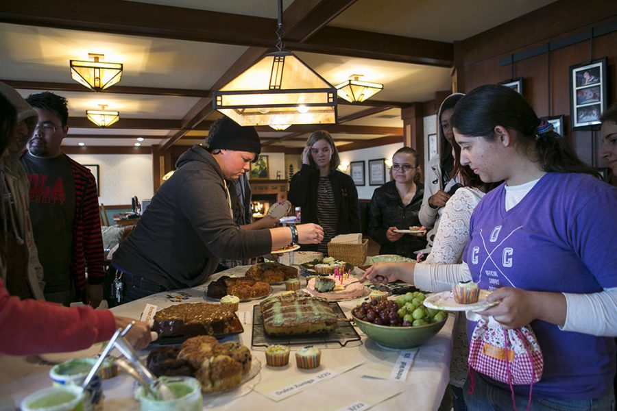 Students gather around the kitchen table in the Collegium to celebrate March birthdays. The Collegium is celebrating its 10-year anniversary. | Tomber Su/THE CHIMES