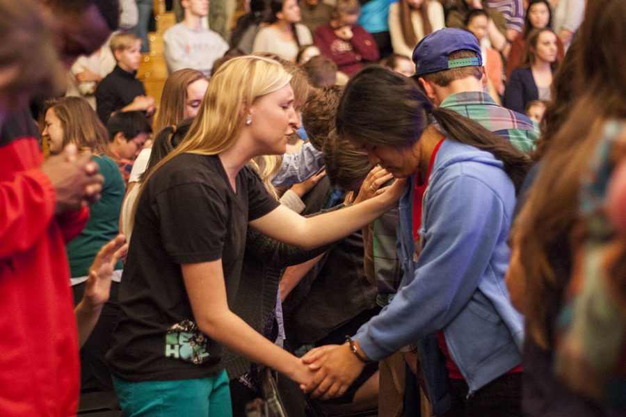 Junior ICS major Lindsay Ahlquist returns a friends prayer of Gods guidance over her life. | Melanie Kim/THE CHIMES