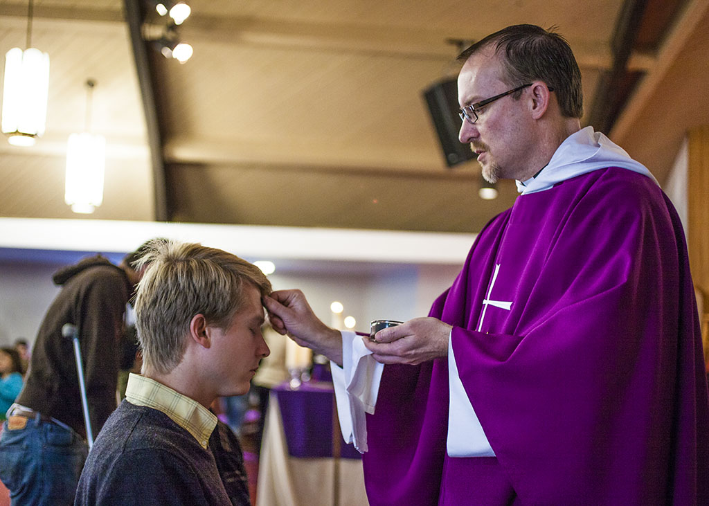 Alumnus Jonathan Rowley ('05), an auxiliary services assistant manager at Biola, receives ashes during the 6:30 a.m. service at the Anglican Church of the Epiphany, held at Redeemer Church on Imperial Highway. Ash Wednesday begins the season of Lent. | Melanie Kim/THE CHIMES