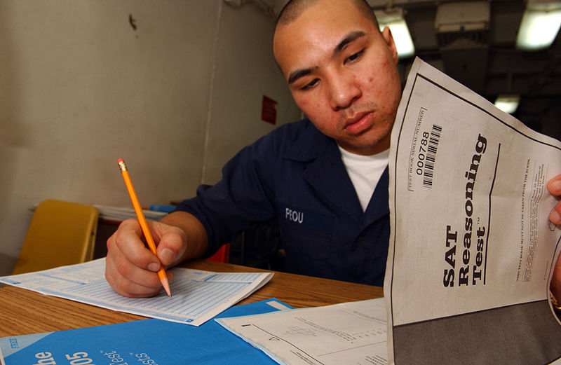 Seaman Chanthorn Peou of San Diego, Calif., takes his Scholastic Aptitude Test (SAT) aboard an aircraft carrier. The changes made to the SAT test do not have a big effect on the college admission process. | wikimedia.com/Creative Commons