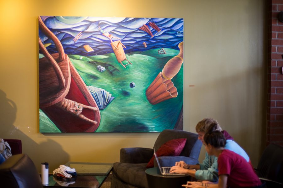 In an attempt to fill the campus with more artwork, several art pieces hang on the walls of the Student Union Building, including this piece next to a section of couches. | Aaron Fooks/THE CHIMES