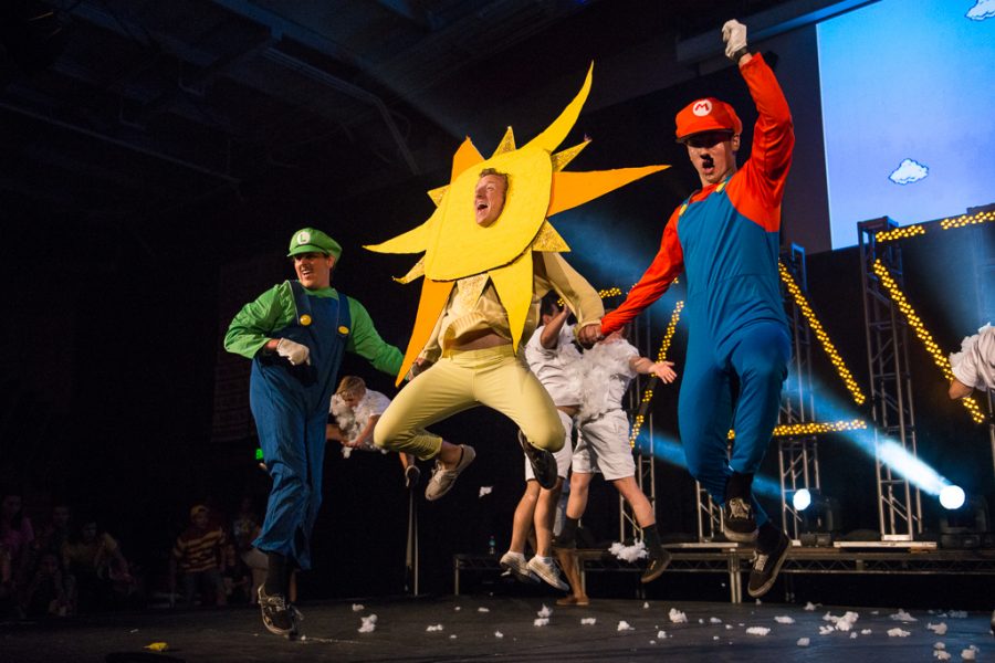 Junior Brad Winsbury, as Luigi and Sam Becker-Miyadai, as Mario jump for joy with Zach Arnold during the Bropoc performance. BroPoc comes out on top, winning first place at Mock Rock with their video game-themed dance. | Olivia Blinn/THE CHIMES