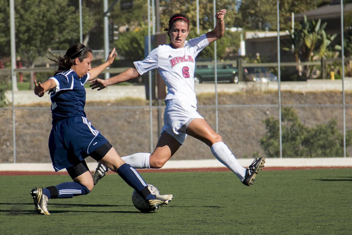 Senior midfielder Miranda Starbeck leaps for the ball at the women's soccer game against Bethesda. Starbeck, who had one goal and two assists, helped the team win with a score of 8-0.  | Aaron Fooks/THE CHIMES