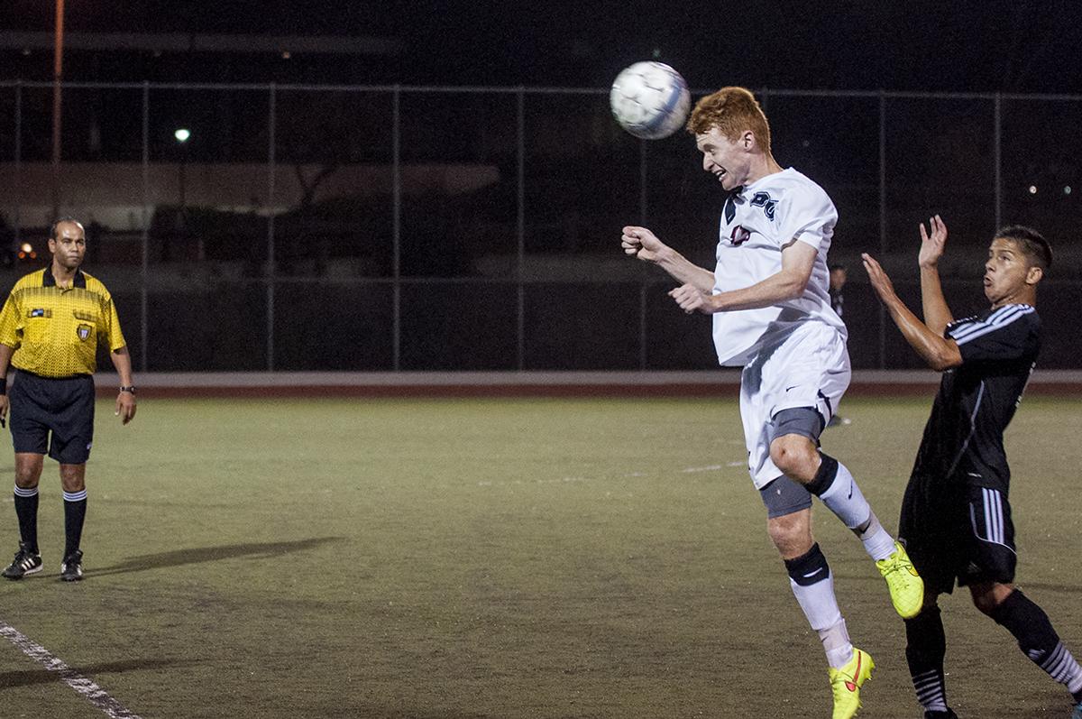 Junior midfielder John Hanscom heads the ball at the men's soccer game against Bethesda College on Labor Day. Biola went on to win their first ever game against Bethesda with a score of 5-2. | Cherri Yoon/THE CHIMES