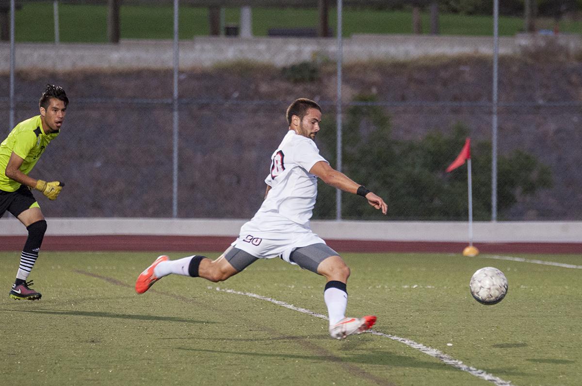 Junior midfielder Stephen Tanquary sneaks the ball past Bethesda's goalkeeper at the game on season opener on Sept 1. Tanquary played exceptionally well, scoring two goals during the game. | Cherri Yoon/THE CHIMES