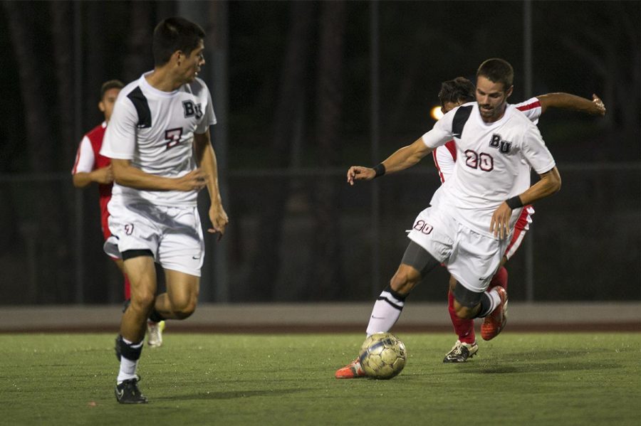 Junior forward Stephen Tanquary dribbles away from Antelope Valley players at the game on Sept 9. Tanquary scored the final goal to help the Eagles win 2-0. | Kalli Thommen/THE CHIMES