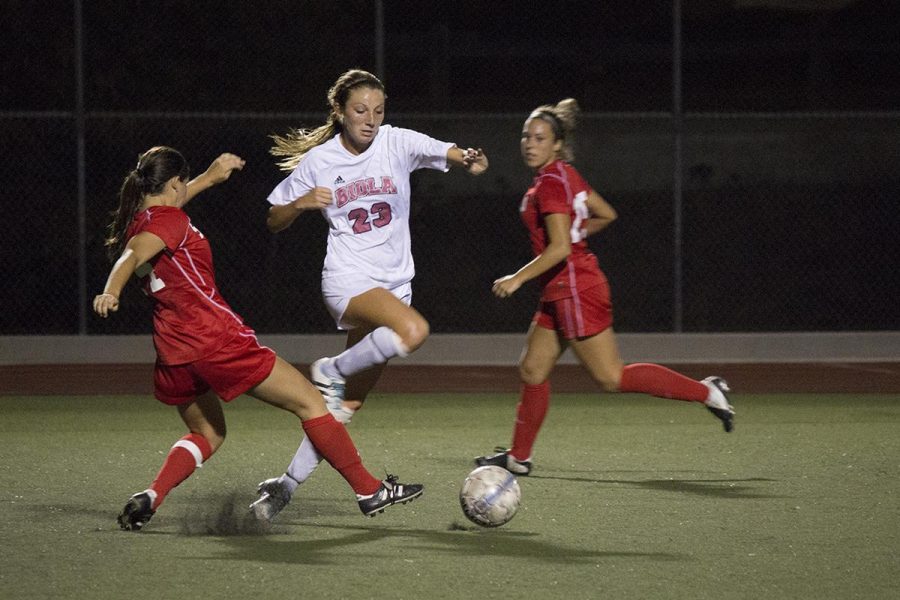 Sophomore forward Taylor Venegas fights through two Southern Oregon University defenders on Sept 10. The Eagles beat the Raiders 2-0 and Venegas made her fourth goal of the season. | Kayla McCabe/THE CHIMES