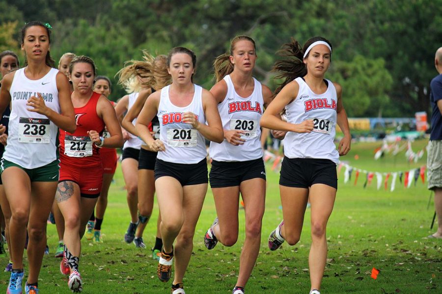 Junior Brooke Arvidson, freshman Stephanie Croy, and sophomore Lyndee Dawson run alongside other schools at the San Diego State Cross Country Invitational. The women's team took first place in the Invitational. | Courtesy of Allan and Jessi Kung