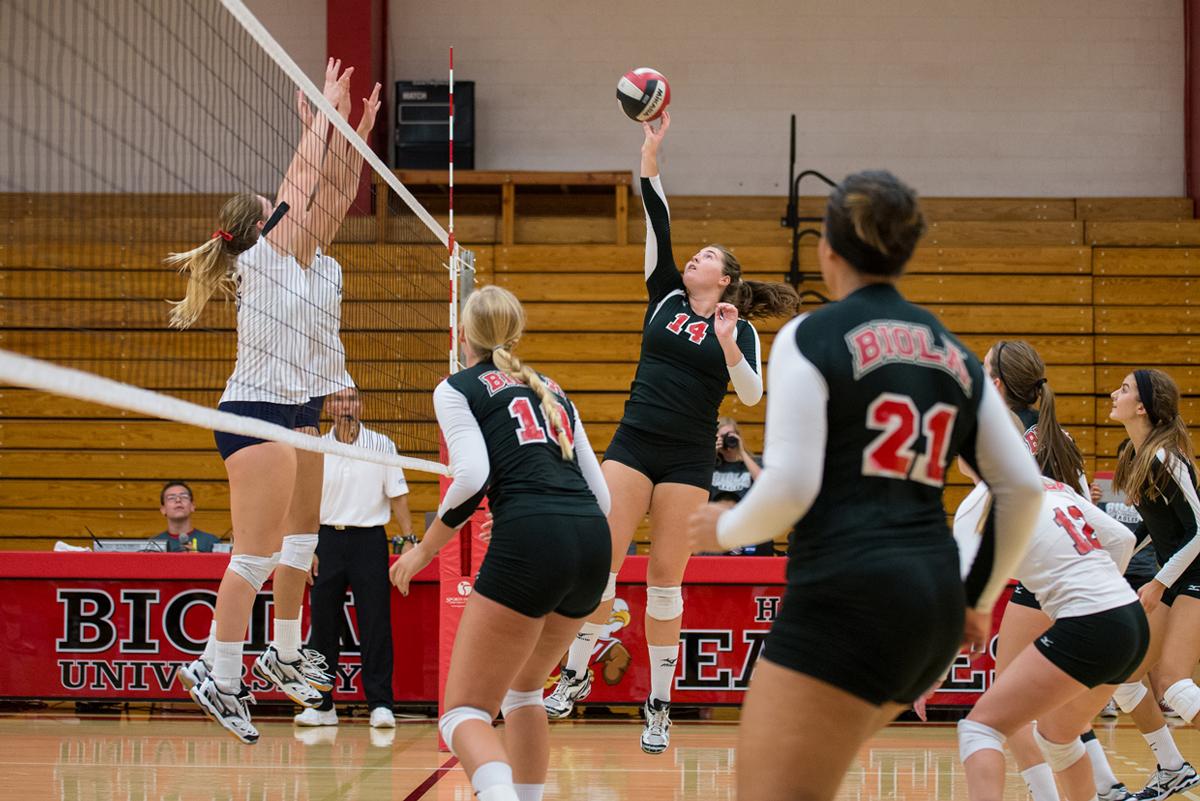 Junior outside hitter Britta Blaser hits the ball towards Hope International's team on Sept 13. | Jenny Oetzell/THE CHIMES