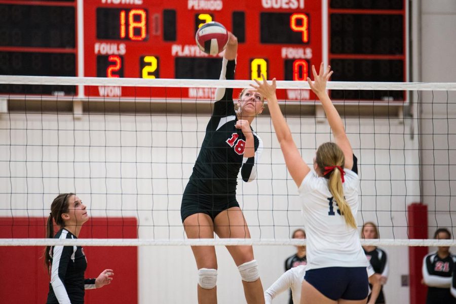 Senior middle blocker Amy Weststeyn attacks the ball for a kill against Hope International on Sept 13. Westsreyn ended the game with a .474 percentage. | Jenny Oetzell/THE CHIMES