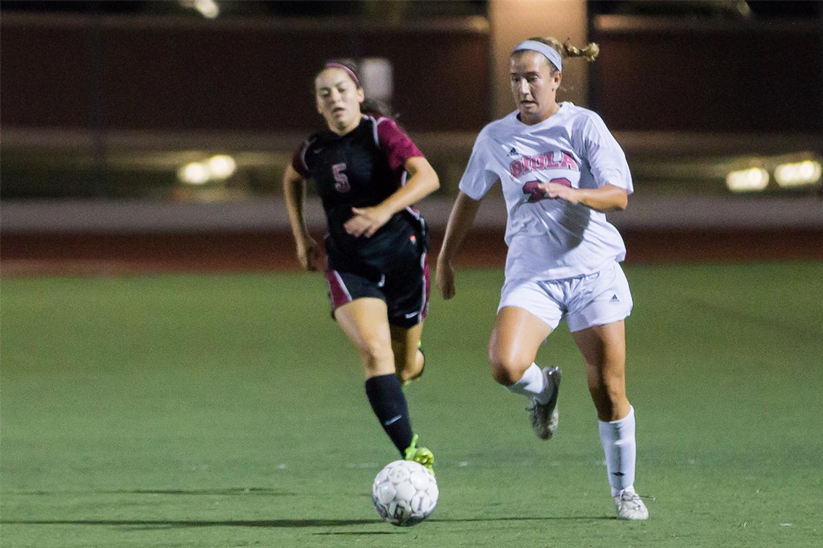 Junior midfielder Amanda Otto battles for the ball against Westmont University on Sept. 30. | Molli Kaptein/THE CHIMES