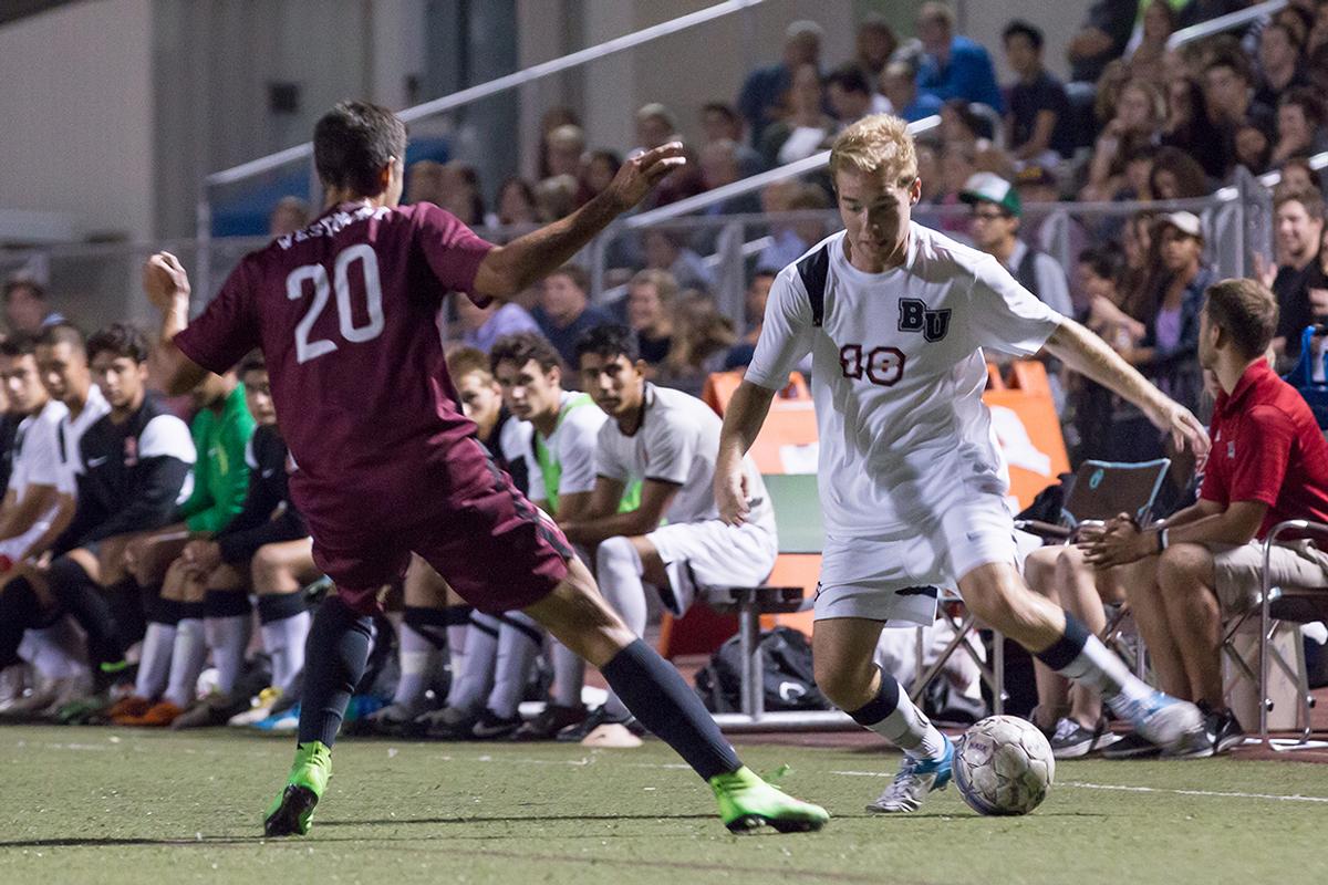 Freshman defense Clayton Mohler avoids a player from Westmont College on Oct. 1. | Ashleigh Fox/THE CHIMES