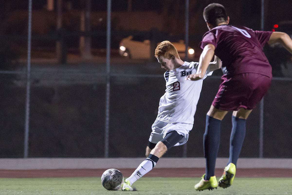 Junior midfielder John Hanscom shoots the ball past a Westmont College on Oct. 1. | Ashleigh Fox/THE CHIMES