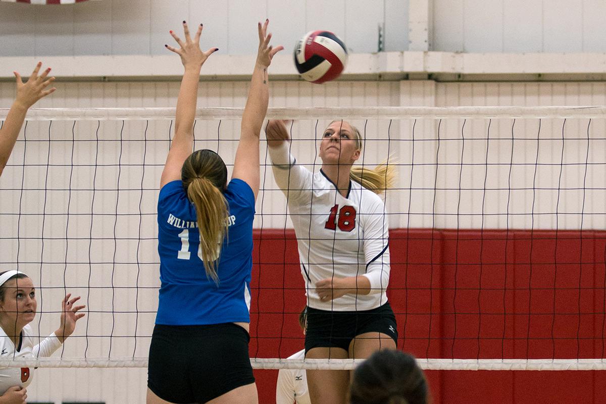 Senior middle blocker Amy Weststeyn spikes the ball down to a William Jessup University player at the game on Oct. 4. | Molli Kaptein/THE CHIMES