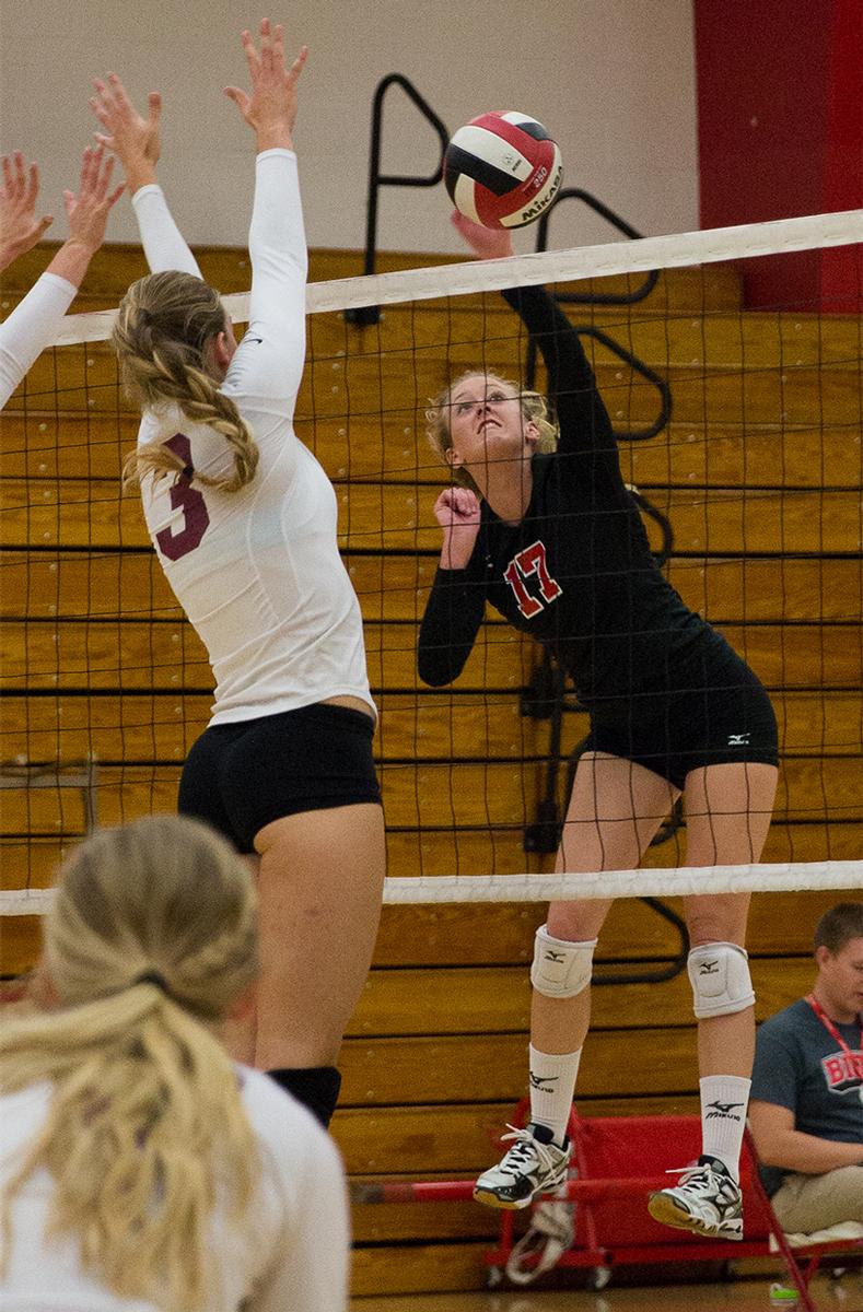 Junior right side hitter Crissy Cunningham spikes the ball down to Westmont College on Oct. 7. | Molli Kaptein/THE CHIMES