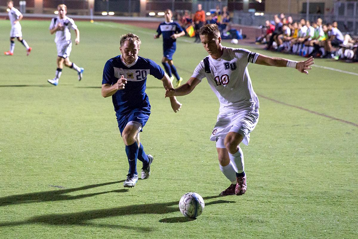 Junior midfielder Joey O'Keefe runs the ball toward the goal at the Oct. 7 game against The Master's College. Though Biola dominated over the Mustangs at GSAC last year, the Eagles lost the game 2-1 last Wednesday. | Johnathan Burkhardt/THE CHIMES