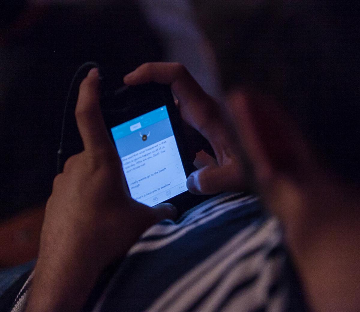 A Biola students updates his Yik-Yak app during Torrey Conference 2014. | Melanie Kim/THE CHIMES