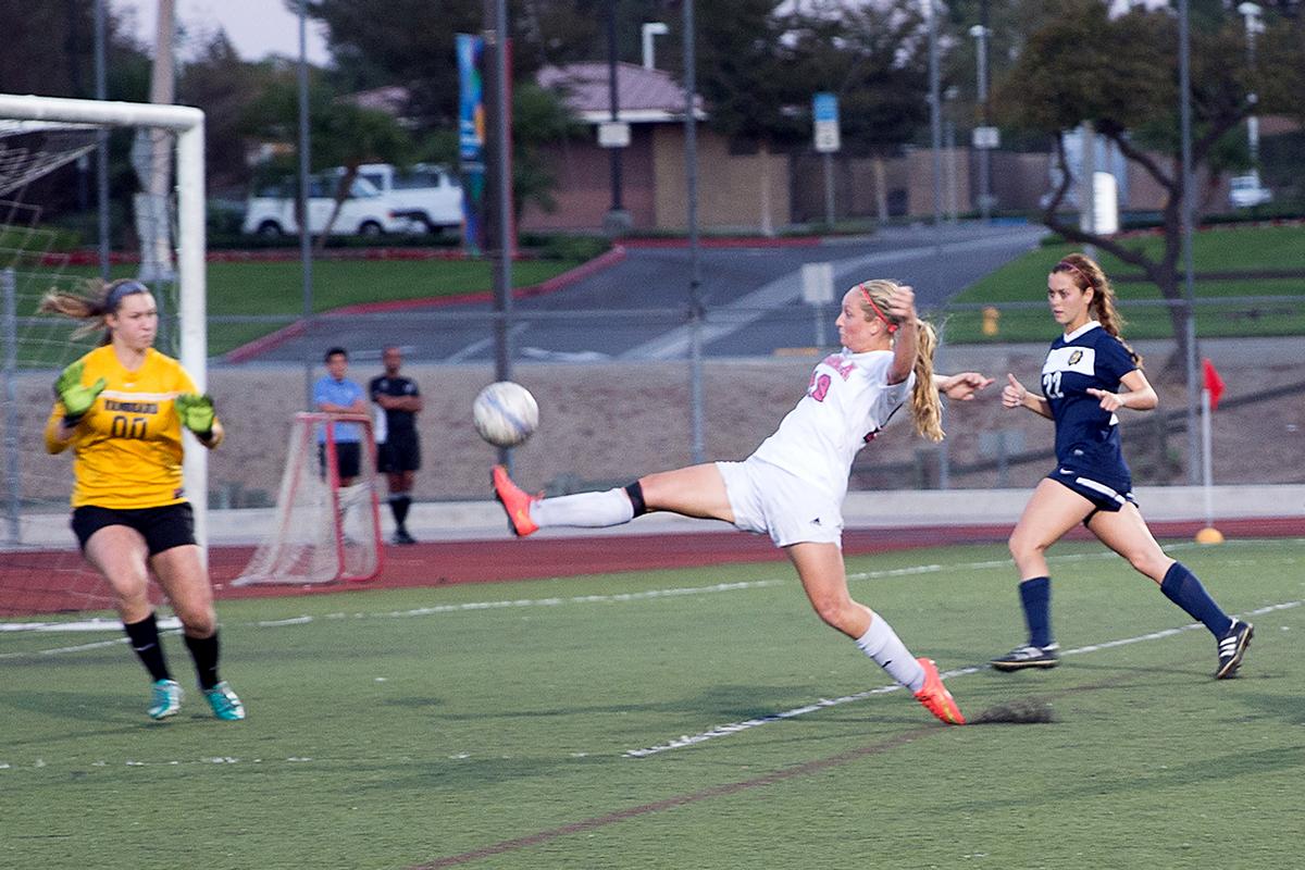 Sophomore midfielder Jessie Burns lunges to score a goal in the last five minutes of the game against Vanguard University on Oct. 18. | Ana Waltschew/THE CHIMES