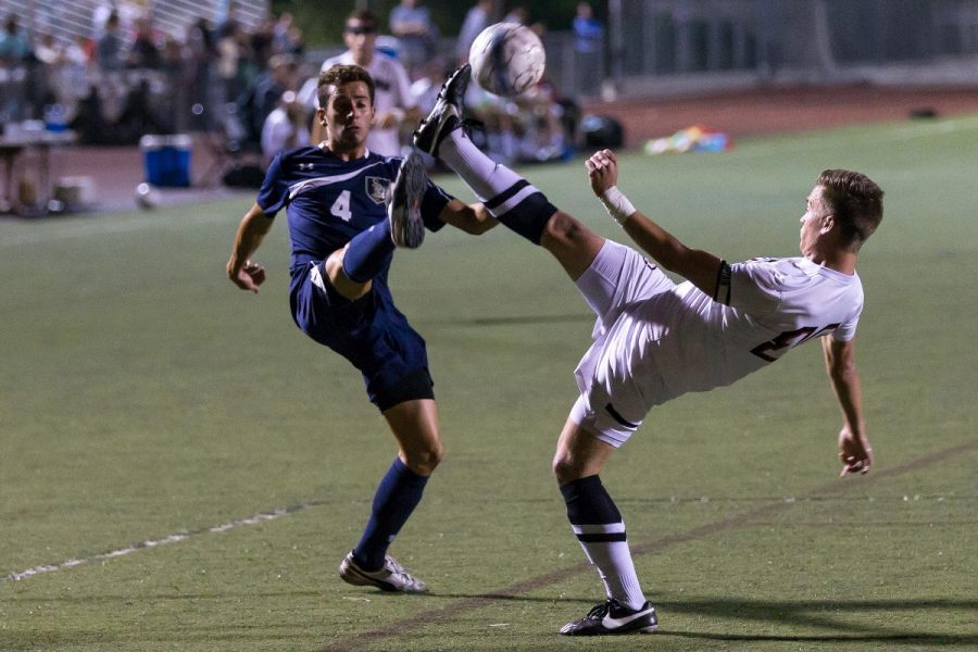 Junior midfielder Joey OKeefe high-kicked for the ball at the game against San Diego Christian College last season. |  Johnathan Burkhardt/THE CHIMES [file photo]