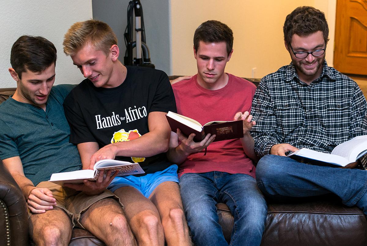 Junior biblical studies majors Charlie Plump, Jeff Sholar, Benjamin Crellin and Connor Stone study together in their home. | Kalli Thommen/THE CHIMES