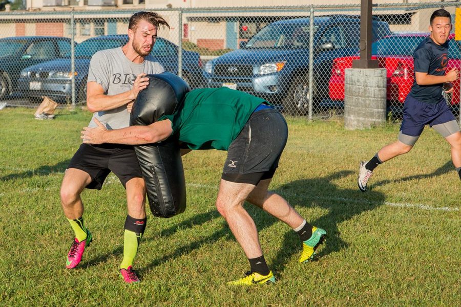 Senior Brock McNeff is tackled by a teammate during rugby practice. | Aaron Fooks/THE CHIMES