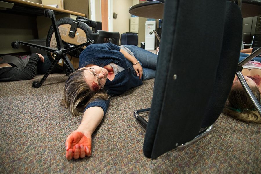 Graduate student Erin Sullenger pretends to be injured at the Shake Out earthquake drill on Oct. 16. | Jenny Oetzell/THE CHIMES
