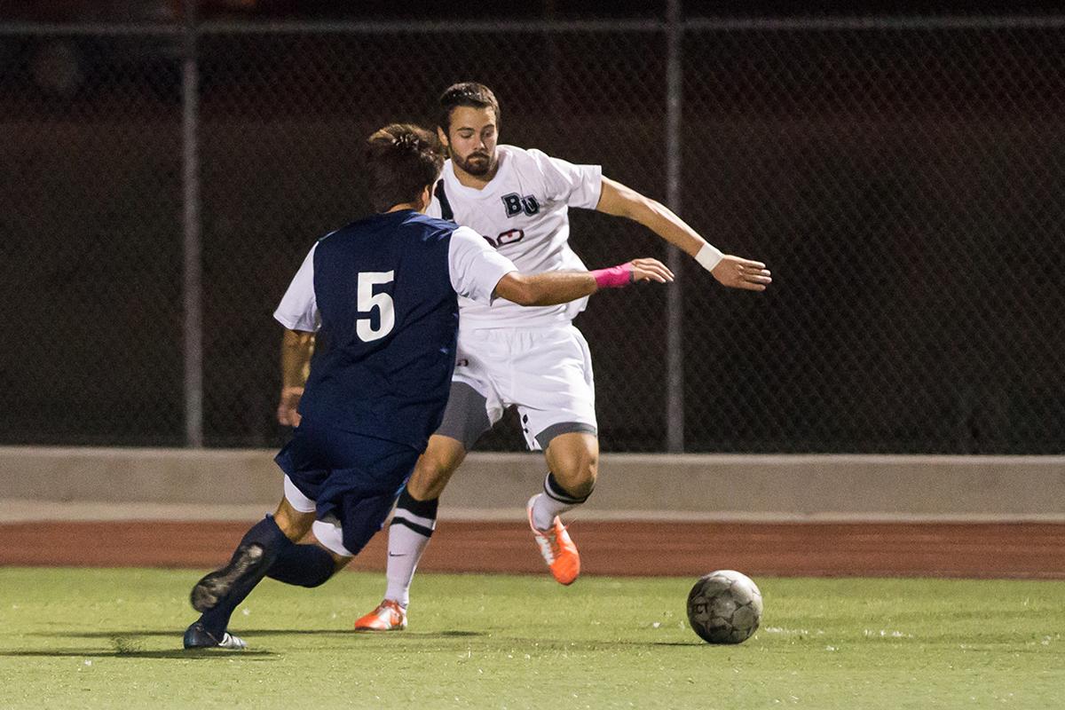 Junior forward Stephen Tanquary dodges past Vanguard University player on Oct. 18. | Marika Adamopoulos/THE CHIMES 