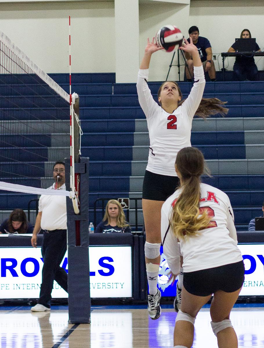 Junior setter Ashton Arbuthnot jumps to set the ball for her teammate at their game against Hope International on Oct. 11. | Johnathan Burkhardt/THE CHIMES 