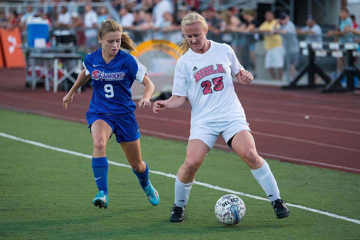 Junior forward Brittney Sayre avoids a player from William Jessup University on Oct. 4. | Jenny Oetzell/THE CHIMES