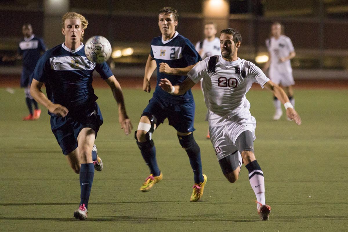 Junior forward Stephen Tanquary chases after the ball alongside players from The Master's College on Oct. 7. After loosing to The Master's College, men's soccer works to redeem their season. | Anna Warner/THE CHIMES