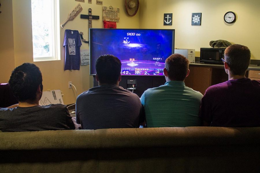 From left to right, freshman Matthew Martinez, Chazz Young, Trevin McConnell, and Dale Fredricks play video games in Horton Hall. | Katie Evensen/THE CHIMES