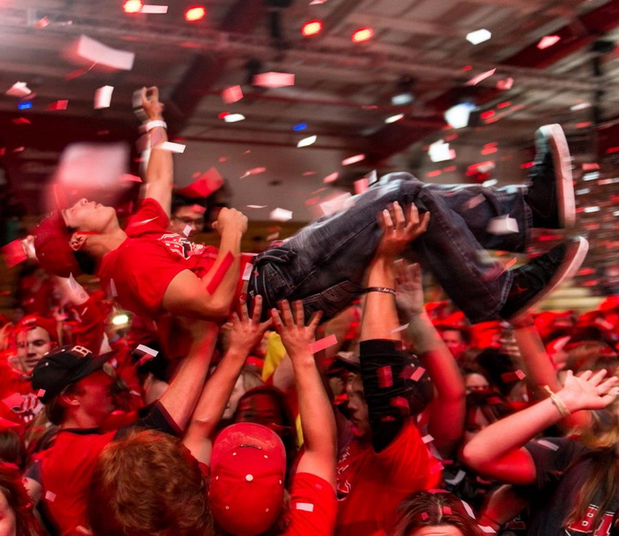 Junior business major Aaron Chavez is held up by the crowd at Midnight Madness last year. 