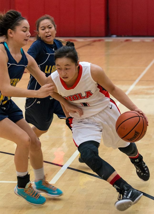 Junior guard Annie Park dodges two players from La Sierra at the game on Wednesday night.  | Aaron Fooks/THE CHIMES