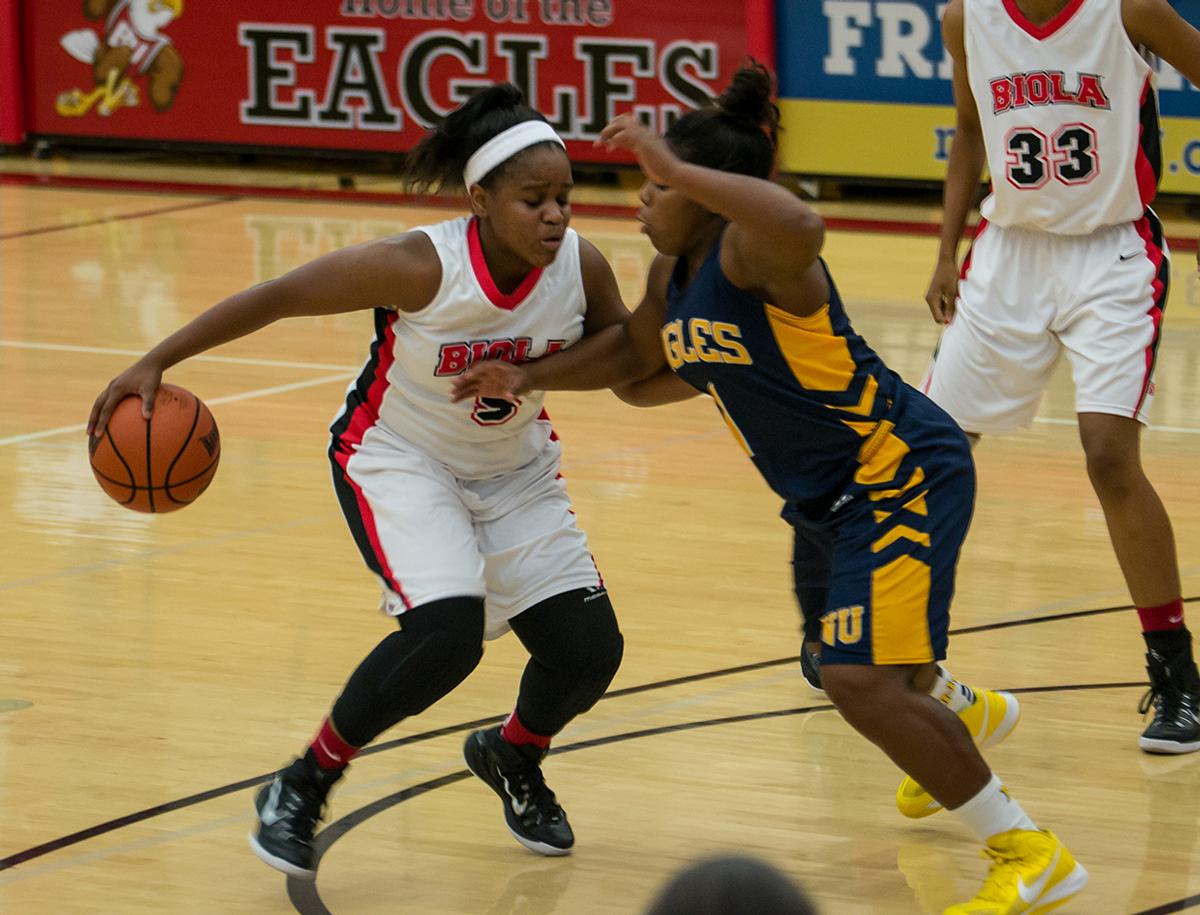 Freshman guard DeMoria White fights of a player from Northwest University on Nov. 8. | Kalli Thommen/THE CHIMES