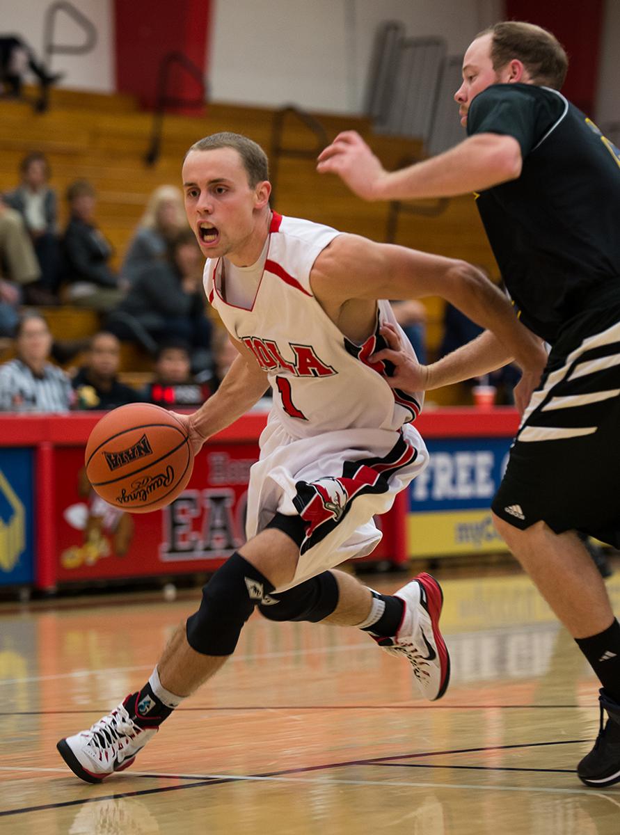 Senior guard Pierre Zook dribbles past a La Sierra player at the game on Nov. 12. | Jenny Oetzell/THE CHIMES