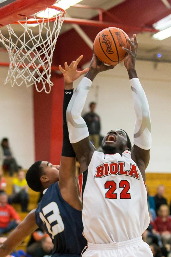 Freshman forward Steve Herve leaps up to dunk the ball against San Diego Christian College on Tuesday Nov. 2. | Molli Kaptein/THE CHIMES