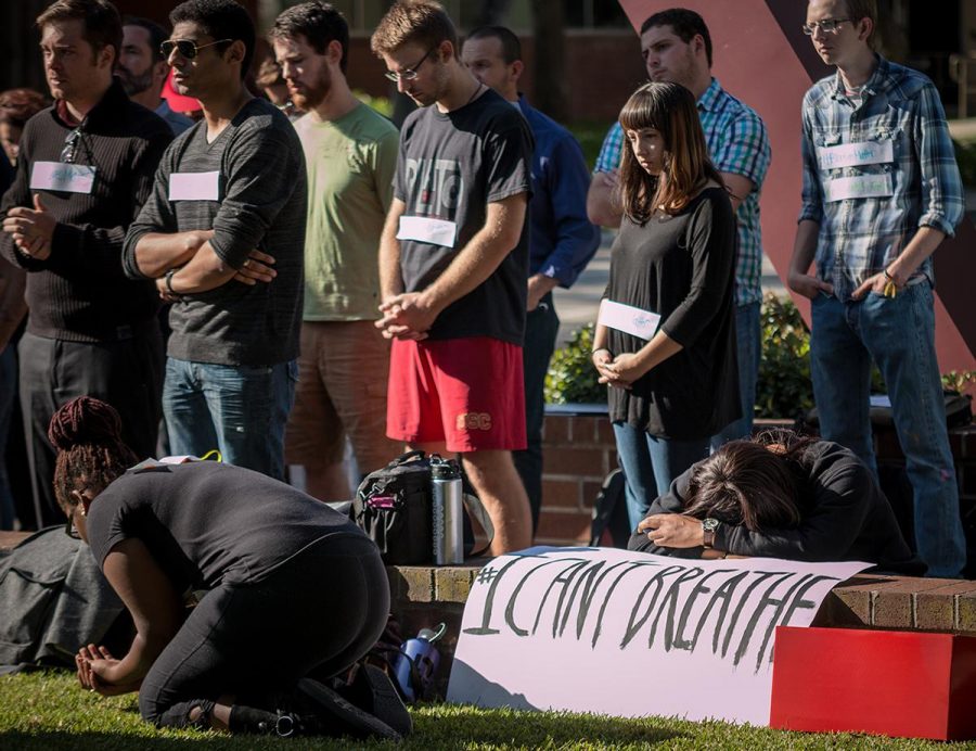 Students gather at the Bell Tower to pray and reflect on the recent incidents in Ferguson. | Aaron Fooks/THE CHIMES
