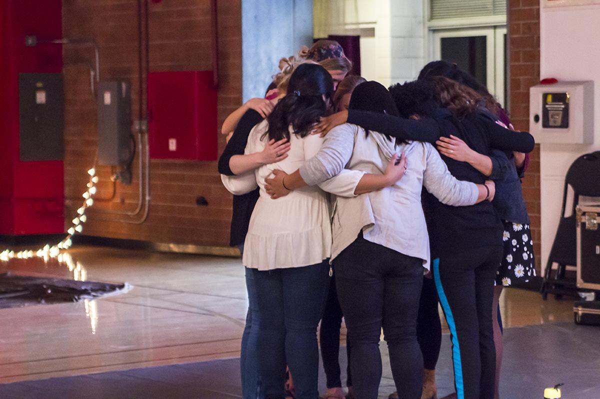 The conference staff gather together in prayer before the event begins.  |   Marika Adamopoulos/THE CHIMES