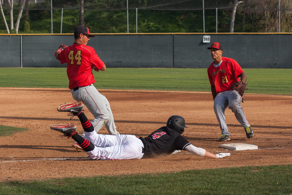 Senior Rob Groeschell slides into base during the game against Arizona Christian. | Melanie Kim/THE CHIMES