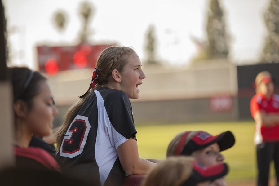 Junior+Heather+Hall+cheering+in+support+of+her+teammate+up+at+bat.+Biola%E2%80%99s+softball+team+finishes+their+two+series+this+week+with+two+splits.+%7C+Melanie+Kim%2FTHE+CHIMES