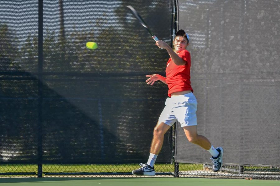 Senior Tayven Townsend returns a ball during his singles match against Arizona Christian University on Feb. 6. The men’s tennis team won and lost one match over this week. | Ashleigh Fox/THE CHIMES [file photo]