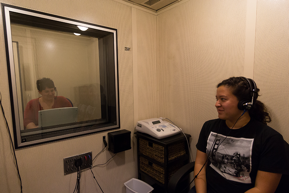 Alicia McCormick, 2013 Biola graduate and administrative coordinator of Communication Sciences and Disorders tests the hearing of senior Ariana Lee.  The Dorothy English Hall now holds the entirety of the communication disorders department.  |  Amber Nunn/THE CHIMES