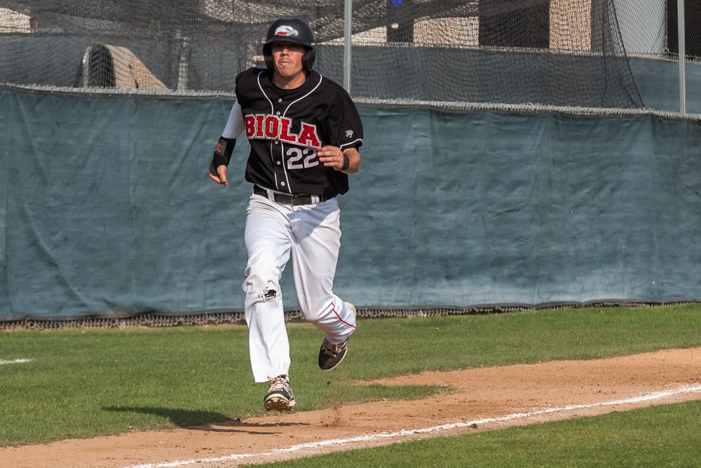 Senior Paul Slater running home during a game against Bethesda University this season. | Melanie Kim/THE CHIMES [file photo]